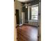 A simple bedroom with hardwood floors, a ceiling fan, and a large window at 708 Palenci Ct, Winter Springs, FL 32708
