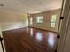 Spacious bedroom featuring hardwood floors, three large windows, and neutral wall colors at 708 Palenci Ct, Winter Springs, FL 32708