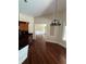 Charming dining area features hardwood floors and a decorative chandelier, adjacent to kitchen at 708 Palenci Ct, Winter Springs, FL 32708