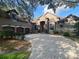 Elegant home with a paver driveway, three-car garage, and beautiful landscaping at 708 Palenci Ct, Winter Springs, FL 32708