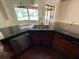 Stainless steel kitchen sink with granite counter, dishwasher, and modern cabinetry at 708 Palenci Ct, Winter Springs, FL 32708