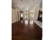 Spacious living room featuring rich wood floors, a ceiling fan, and large windows at 708 Palenci Ct, Winter Springs, FL 32708