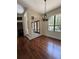 Bright, airy living room with dark wood floors, large windows, and elegant chandelier at 708 Palenci Ct, Winter Springs, FL 32708