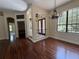 Bright, airy living room with dark wood floors, large windows, and elegant chandelier at 708 Palenci Ct, Winter Springs, FL 32708