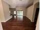 Open-concept living area with wood floors, a view of the pool, and plenty of space at 708 Palenci Ct, Winter Springs, FL 32708