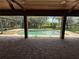 Tranquil pool area under a screened lanai with brick pavers and a wooded view at 708 Palenci Ct, Winter Springs, FL 32708