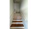 A wood staircase with white painted risers at 708 Palenci Ct, Winter Springs, FL 32708