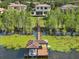 Stunning aerial view of a waterfront estate with a private dock and boat lift on a serene lake at 7624 Pointe Venezia Dr, Orlando, FL 32836