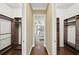 Walk-in closet with wood shelving and drawers provides ample storage space, seamlessly accessible from the hallway at 7624 Pointe Venezia Dr, Orlando, FL 32836