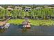 Waterfront home with a private boat dock, surrounded by lush greenery, offering a serene and luxurious living experience at 7624 Pointe Venezia Dr, Orlando, FL 32836