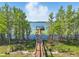 A private dock extends to a covered boat house, offering direct water access and scenic views, creating waterfront bliss at 7624 Pointe Venezia Dr, Orlando, FL 32836