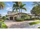 Mediterranean style home with a tile roof, manicured landscaping, and a circular driveway at 7624 Pointe Venezia Dr, Orlando, FL 32836