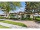 Well-maintained home featuring manicured landscaping, a paver driveway, and a tile roof at 7624 Pointe Venezia Dr, Orlando, FL 32836