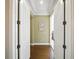 Bright hallway with hardwood floors, white trim, and recessed lighting offers a welcoming entrance to the home at 7624 Pointe Venezia Dr, Orlando, FL 32836