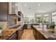 Gourmet kitchen with granite countertops, stainless steel appliances, and a center island at 7624 Pointe Venezia Dr, Orlando, FL 32836