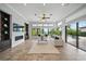 Bright living room with a fireplace, large windows, and access to the pool area at 7624 Pointe Venezia Dr, Orlando, FL 32836