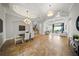 Formal living and dining area with tray ceilings, tile floors, and staircase at 7624 Pointe Venezia Dr, Orlando, FL 32836