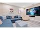 This finished basement features a large sectional sofa, a tv, and plush seating for movie nights at 7644 Fairfax Dr, Kissimmee, FL 34747