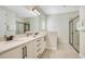Bright bathroom featuring double sink vanity with granite countertop and glass enclosed shower at 7644 Fairfax Dr, Kissimmee, FL 34747