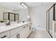 Bright bathroom featuring double sink vanity with granite countertop and glass enclosed shower at 7644 Fairfax Dr, Kissimmee, FL 34747