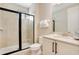 Modern bathroom showcasing a tiled shower and sleek white vanity with granite counters at 7644 Fairfax Dr, Kissimmee, FL 34747