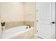 A bathtub with a tiled surround complements the serene bathroom, providing a tranquil retreat at 7644 Fairfax Dr, Kissimmee, FL 34747