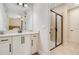 Elegant bathroom with a glass-enclosed shower and granite countertop vanity at 7644 Fairfax Dr, Kissimmee, FL 34747