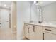 Bright bathroom featuring a white vanity with granite countertop and neutral tile flooring at 7644 Fairfax Dr, Kissimmee, FL 34747