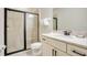 A well-lit bathroom featuring a single vanity and glass enclosed shower at 7644 Fairfax Dr, Kissimmee, FL 34747