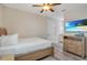 Cozy bedroom with wood floors, a TV, and convenient bathroom access at 7644 Fairfax Dr, Kissimmee, FL 34747
