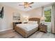 Cozy bedroom showcasing stylish décor, a ceiling fan, and ample natural light at 7644 Fairfax Dr, Kissimmee, FL 34747