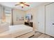 Cozy bedroom with a modern ceiling fan, wood laminate flooring, and a closet with sliding doors at 7644 Fairfax Dr, Kissimmee, FL 34747