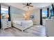 Relaxing bedroom featuring a large bed, light wood floors, and a ceiling fan at 7644 Fairfax Dr, Kissimmee, FL 34747
