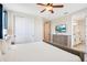 Spacious bedroom with neutral tones, a TV, and an attached bathroom at 7644 Fairfax Dr, Kissimmee, FL 34747