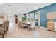 Elegant dining area with a large table, chandelier lighting, and bright blue accent wall at 7644 Fairfax Dr, Kissimmee, FL 34747