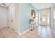 Inviting foyer with neutral tile flooring, a console table and a decorative mirror at 7644 Fairfax Dr, Kissimmee, FL 34747