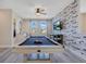 A well-lit game room has a full-size pool table, contemporary wet bar, and decorative accent wall at 7644 Fairfax Dr, Kissimmee, FL 34747