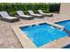 Hot tub with lounge chairs and nicely designed brick floor at 7644 Fairfax Dr, Kissimmee, FL 34747