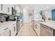 Modern kitchen with stainless steel appliances, white cabinetry, granite countertops, and tiled backsplash at 7644 Fairfax Dr, Kissimmee, FL 34747