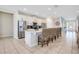 Modern kitchen featuring white cabinets, stainless steel appliances, a large island, and counter seating at 7644 Fairfax Dr, Kissimmee, FL 34747