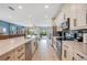 Well-lit kitchen featuring an island with seating, stainless appliances, and a seamless transition to the living area at 7644 Fairfax Dr, Kissimmee, FL 34747