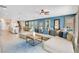 Open-concept living area with large sectional sofa and seamless flow to dining and kitchen at 7644 Fairfax Dr, Kissimmee, FL 34747