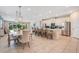 Open concept living space featuring kitchen, dining, and living area with an island and stainless appliances at 7644 Fairfax Dr, Kissimmee, FL 34747