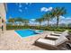 A beautiful pool and spa are surrounded by lounge chairs and well kept landscaping at 7644 Fairfax Dr, Kissimmee, FL 34747