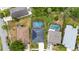 Aerial view of homes with screened pools and solar panels in a residential neighborhood, surrounded by lush greenery at 826 Jade Forest Ave, Orlando, FL 32828