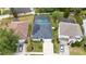 Aerial view of a single-Gathering home with solar panels and a screened-in pool in a residential neighborhood at 826 Jade Forest Ave, Orlando, FL 32828