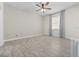 Spacious bedroom with neutral tones, ceiling fan, and ample natural light from the window at 826 Jade Forest Ave, Orlando, FL 32828