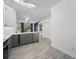 Modern kitchen featuring grey and white cabinetry, stainless steel appliances, and a view of the outdoor pool at 826 Jade Forest Ave, Orlando, FL 32828