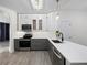 Tastefully renovated kitchen with white upper cabinets, gray lower cabinets, and modern appliances at 826 Jade Forest Ave, Orlando, FL 32828