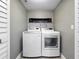 Efficient laundry room with modern, side-by-side washer and dryer units at 826 Jade Forest Ave, Orlando, FL 32828